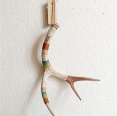 an animal made out of yarn hanging on a wall