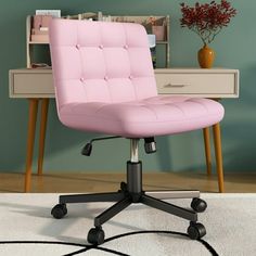 a pink office chair sitting on top of a white rug in front of a desk