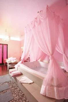 a bedroom with a pink bed and bathtub