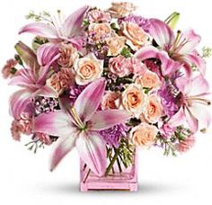 a vase filled with pink and white flowers