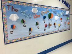 a bulletin board with hot air balloons and the words sky's the limit on it