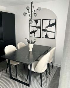 a black and white dining room table with chairs