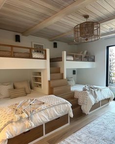 a bedroom with bunk beds and stairs leading to the upper floor, while another bed is on the lower level