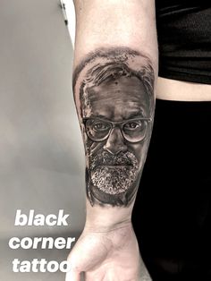 a man's arm with a black and grey portrait on it