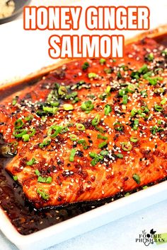 honey ginger salmon in a white dish with sesame seeds on top