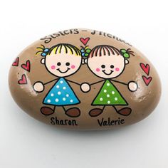 two children holding hands painted on a rock with hearts and the words st louis and saint valerie