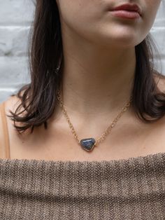 This stunner of a necklace features a single, irregular, faceted chunk of labradorite, a subtle grey stone that swims with shades of iridescent green, blue, and purple. Each necklace will resemble the one shown, but no two are exactly alike. Set on a gorgeous hammered circle chain that sparkles in the light. 14 kt gold fill chain with labradorite stone Handmade in the USA Ash & Rose exclusive Stone shape and size will vary by necklace. Magnetic Closure 16" long Labradorite Jewelry With Raw Stone As Gift, Blue Labradorite Jewelry With Large Stone, Blue Gemstone Necklace In Labradorite, Blue Labradorite Gemstone Necklace, Tanzanite Faceted Necklace For Gift, Gift Tanzanite Faceted Necklace, Everyday Faceted Labradorite Jewelry, Unique Labradorite Necklace With Large Stone, One Of A Kind Labradorite Necklaces For Gifts