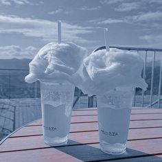 two ice cream sundaes sitting on top of a table next to each other