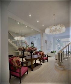 a living room filled with furniture next to a staircase