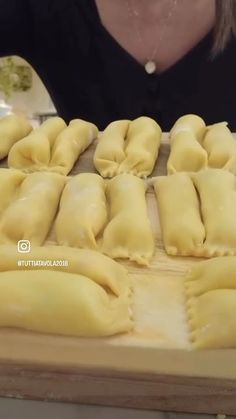 some dumplings are on a wooden cutting board