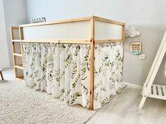 a baby crib in the corner of a room next to a ladder and bed