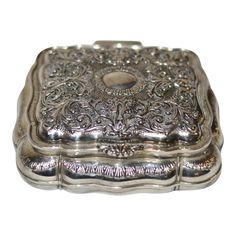 an ornate silver box is shown on a white background