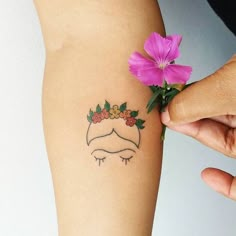 a woman's arm with a tattoo on it and a flower in the middle