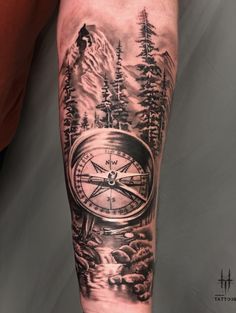 a man's arm with a clock and trees on it, in black and grey