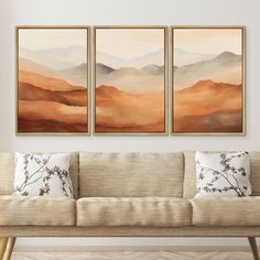 three paintings hanging on the wall above a couch