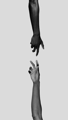 two hands reaching for each other in the air with one hand extended up to another