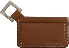 Buffed leather and grained leather card holder in tan and brown. · Logo embossed at face · Central note slot · Four card slots · Logo-engraved carabiner at side · Contrast stitching in off-white · H2.5 x W4 Supplier color: Light brown Brown Travel Card Holder With Key Clip, Rectangular Leather Card Holder In Cognac, Brown Bifold Card Holder With Interior Key Chain, Brown Rectangular Card Holder With Key Clip, Brown Logo, Leather Card Holder, Card Holder Leather, Contrast Stitch, Light Brown