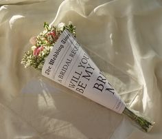 a bouquet of flowers laying on top of a white sheet