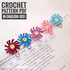 the crochet pattern is in english and has flowers attached to each side of it