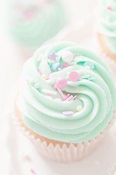 cupcakes with frosting and sprinkles on a plate