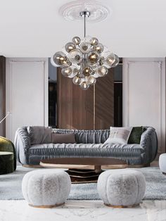 a modern living room with grey couches and marble tables