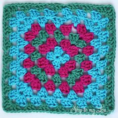 a crocheted square with pink and green flowers