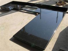 a large black table sitting on top of a cement floor