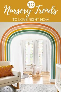 a baby's room with a rocking horse and rainbow painted walls