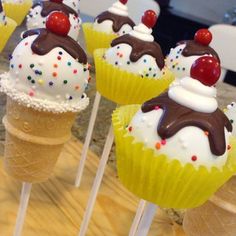 cupcakes with chocolate frosting and sprinkles are on top of ice cream cones