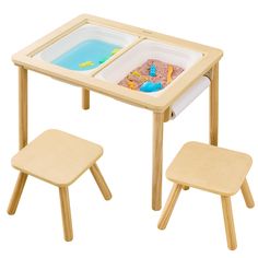 a child's table and two stools set up to play with sand and water