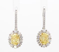 RareGemWorld's classic diamond earrings. Mounted in a beautiful 18K Yellow and White Gold setting with natural oval cut yellow diamonds. The yellow diamonds are surrounded by a halo of small round natural white diamond melee. These earrings are guaranteed to impress and enhance your personal collection! Total Weight: 2.19cts Length x Width: 23.8 x 8.8 mm Center Diamond Measurements: 6.5 x 4.7 mm Side Diamond Measurements: .89 - .98 & 2.0 - 2.1 mm Natural Oval Yellow Diamonds  Natural Round White Diamonds 18K Yellow/White Gold All diamonds are guaranteed natural International Shipments: Please note that customers are responsible for all import duties and taxes applicable to the country of shipment Returns: Returns accepted in original format within 14 days of receipt Do not forget to view o Classic Diamond Earrings, Yellow Diamonds, White Gold Set, Gold Drop Earrings, Yellow Diamond, Oval Diamond, White Diamonds, Oval Cut, Jewelry Earrings Studs