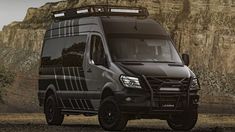 a black van parked in front of a mountain