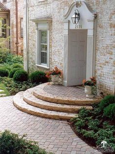 a brick house with steps leading up to the front door