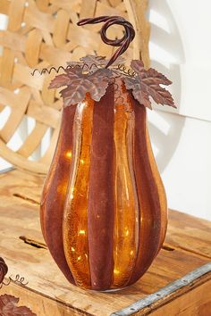 a decorative glass vase sitting on top of a wooden table