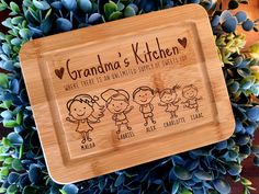 personalized bamboo cutting board for grandma's kitchen with family pictures and names on it