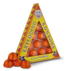 a triangle shaped candy box with orange candies in it's bottom and an image of a face on the top