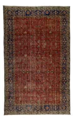 an antique rug with red and blue colors