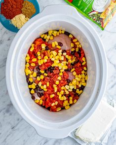 an image of corn and seasoning in a bowl on the counter top with other ingredients