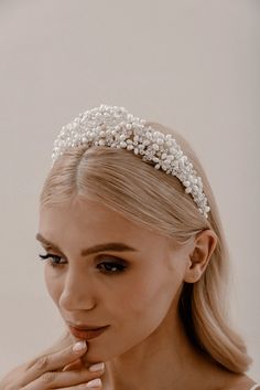 Pearl Regalia Headband Elevate your bridal hairstyle with Pearl Regalia Headband, featuring clear glass and pearls. This accessory adds a touch of timeless elegance to any wedding day look, with delicate detailing that sparkles in the light. Whether you're wearing your hair up or down, this headband is the perfect finishing touch to complete your bridal ensemble. Pearl Bridal Headband With Veil, Elegant Wedding Jewelry Headband, Elegant Silver Bridal Headband, Beaded Hair Accessories For Wedding, Elegant Teardrop Crown Wedding Headpiece, Elegant Silver Crown For Wedding, Elegant Silver Crown Headband, Elegant Adjustable Bridal Accessories, Elegant Crown Shaped Hair Accessories With Matching Headband