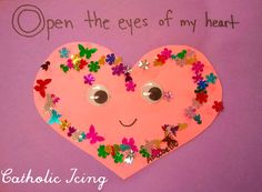 a paper heart with flowers and butterflies on it, says open the eyes of my heart