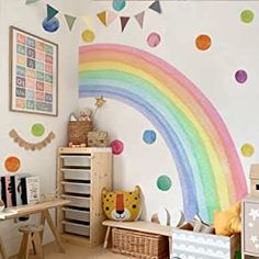 a child's room with a rainbow painted on the wall