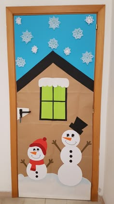 a door decorated with snowmen in front of a house