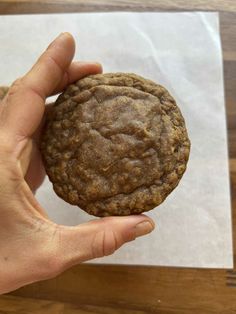 a person holding a cookie in their hand