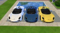 three different colored sports cars parked in front of a pool