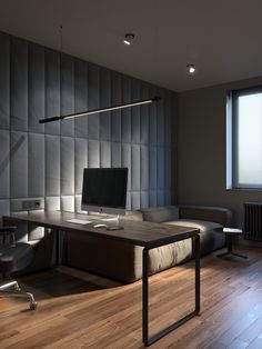 an office space with a desk, chair and computer monitor on top of the desk