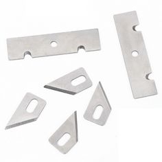 an assortment of stainless steel parts on a white background with clippings and holes