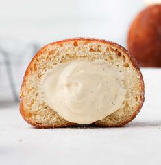 a piece of bread that has some kind of cream on it and is half eaten