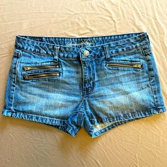 This Is A Pair Of Denim Shorts By American Eagle. Size 14 Regular. Zippered Pockets. Made In China. 100% Cotton. In Excellent Used Condition. Approximate Measurements: 18” Waist, 10 1/2” Front Length, 3” Inseam With An 8 1/2” Rise. Measurements Were Taken With The Shorts Lying Flat. I Ship From A Smoke-Free, Pet-Free, Gluten-Free Home. All Items Are Laundered Or Dry Cleaned (Unless They Are Nwt), Pressed And Stored Until You Order. Denim Jean Shorts With Zipper Closure, Casual Jean Shorts With Zipper Closure, Denim Zip Fly Shorts, Made In China, Zipper Pocket, American Eagle Outfitters, American Eagle, Denim Shorts, Gluten Free