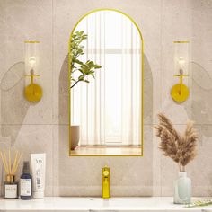 a bathroom with a sink, mirror and plants on the counter