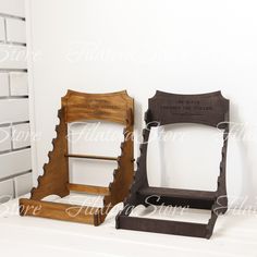 two wooden chairs sitting next to each other on top of a white tablecloth covered floor